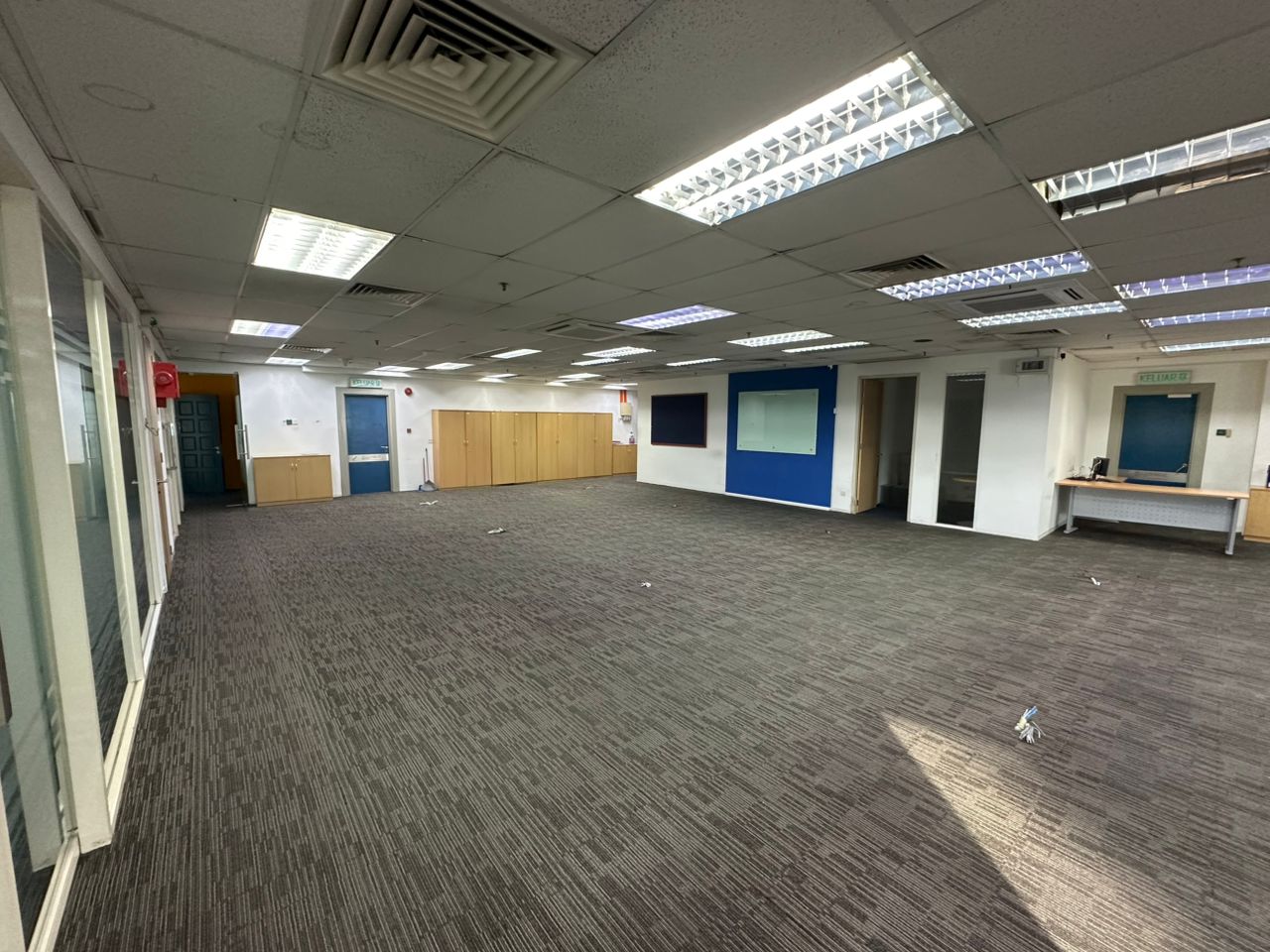Open office area with storage cabinets, partitioned rooms and ceiling lighting at Plaza Sentral, KL Sentral.