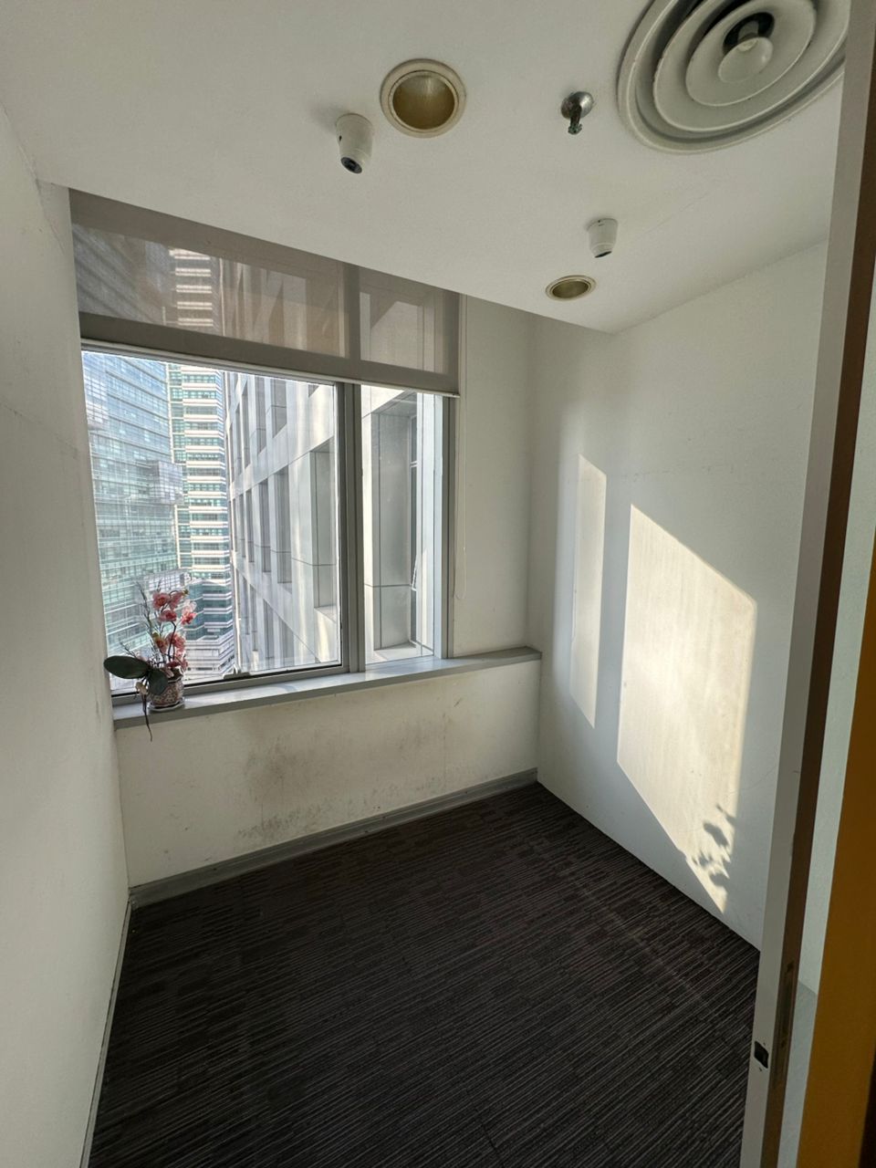 Window-side carpeted room with roller blinds in the supplied Plaza Sentral fitted office sale listing photos.