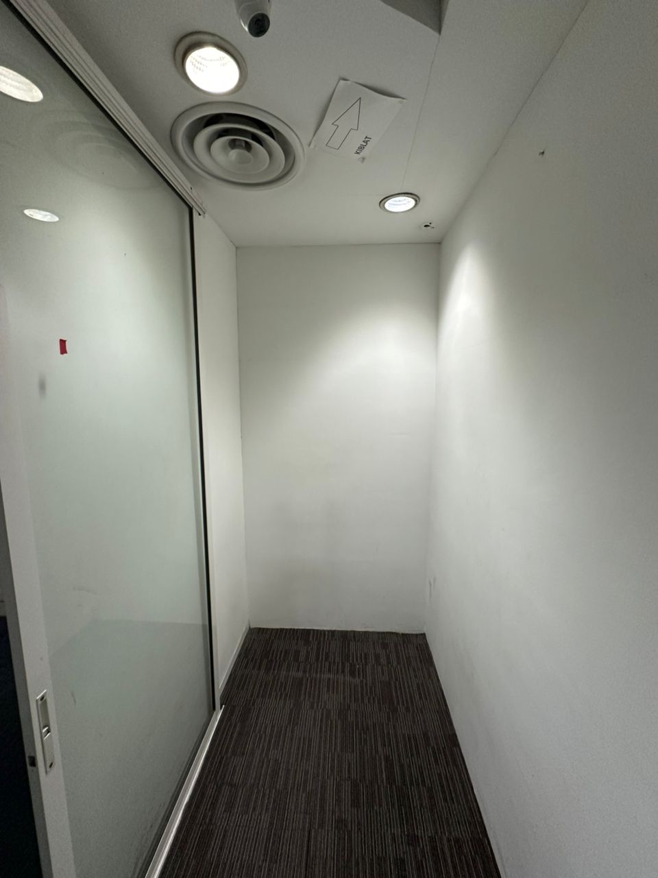 Carpeted room beside a glass partition in the supplied photos of a fitted Plaza Sentral office for rent in KL Sentral.