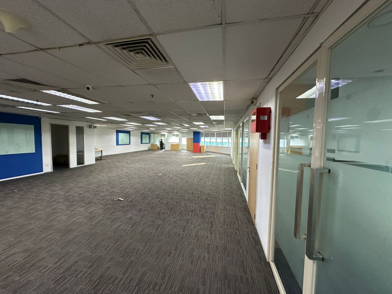 Open office workspace with glass-partitioned rooms and an existing ceiling fit-out at Plaza Sentral, KL Sentral.